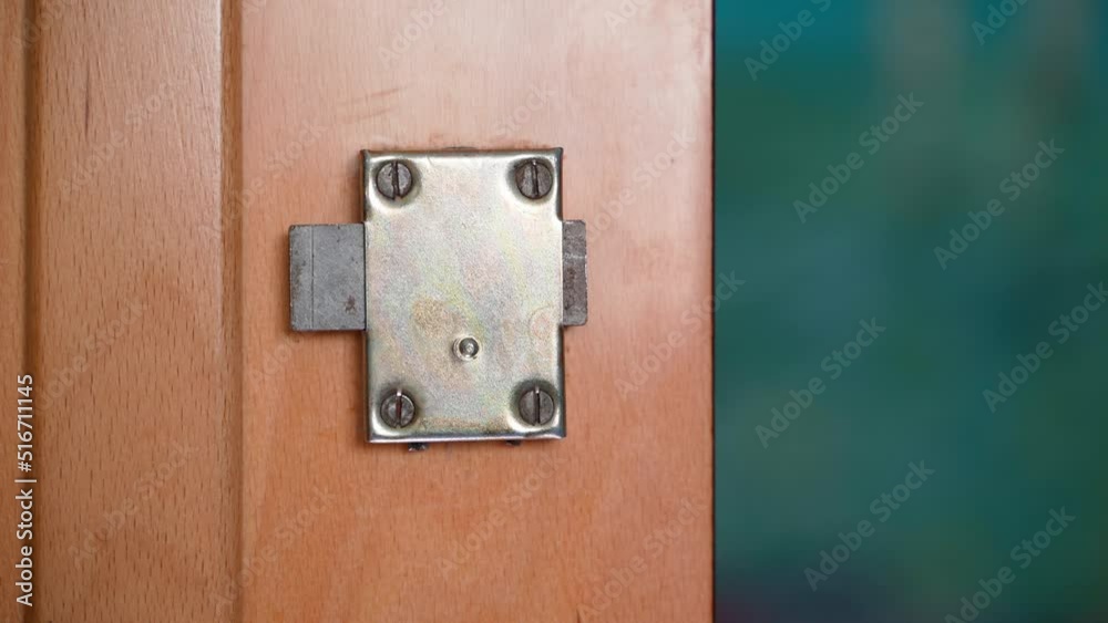 Door lock in an old closet. Accessories of old furniture. Door lock movement close-up Door lock in an old closet. Accessories of old furniture. Door lock movement close-up
