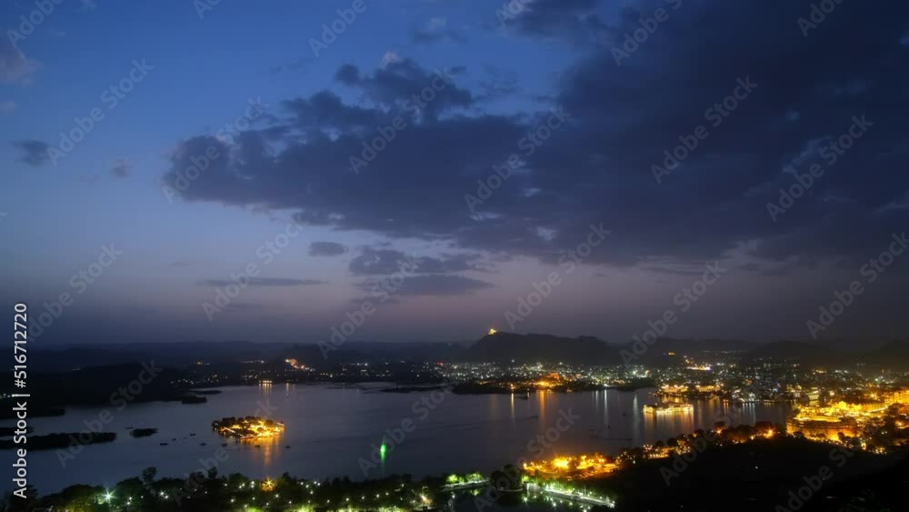 Evening view of Udaipur city skyline and lake Pichola time lapse 4K footage seen from Udaipur view point. Udaipur city, Rajasthan, India. Evening view of Udaipur city skyline and lake Pichola time lapse 4K footage seen from Udaipur view point. Udaipur city, Rajasthan, India.