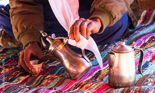 Photo of traditional arabic tea pot and cup. Bedouin tea, traditional tea