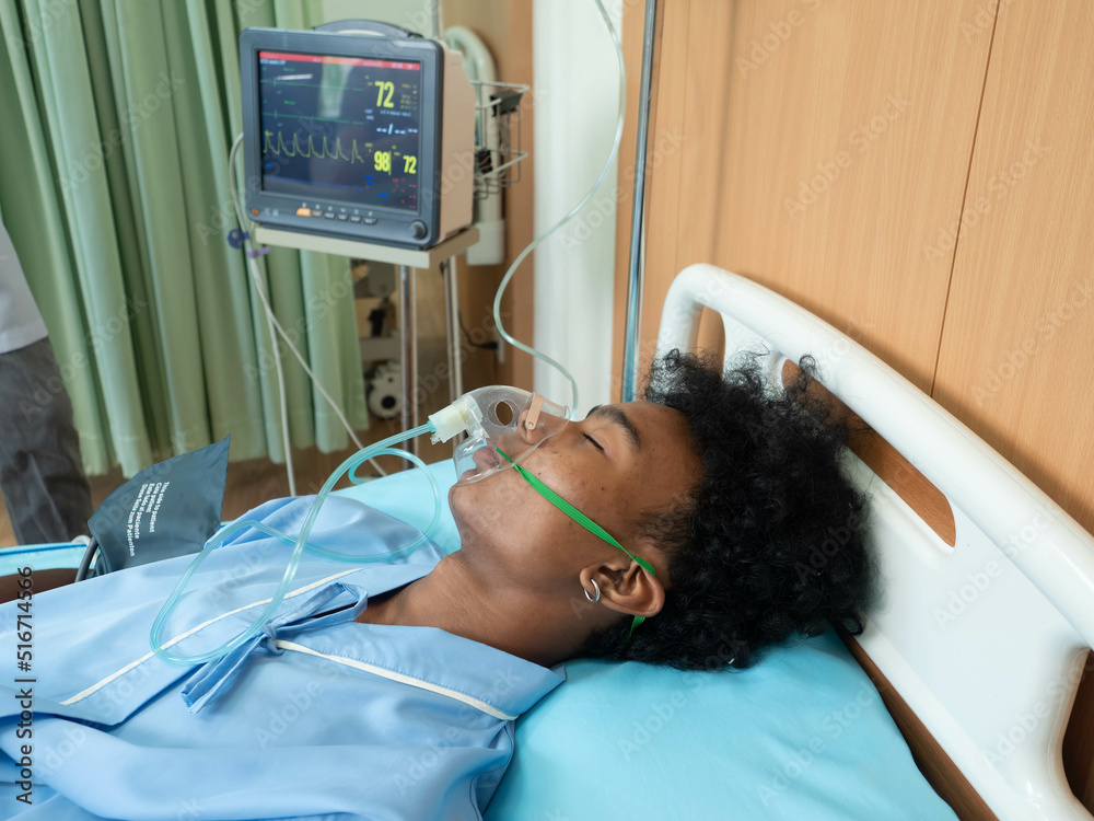 At hospital intensive care unit patient in coma lay on bed ...