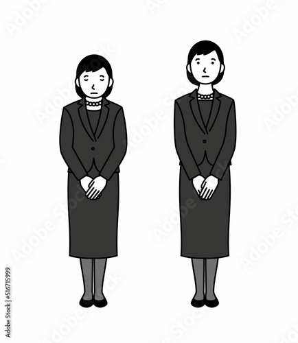 お辞儀をする喪服の女性