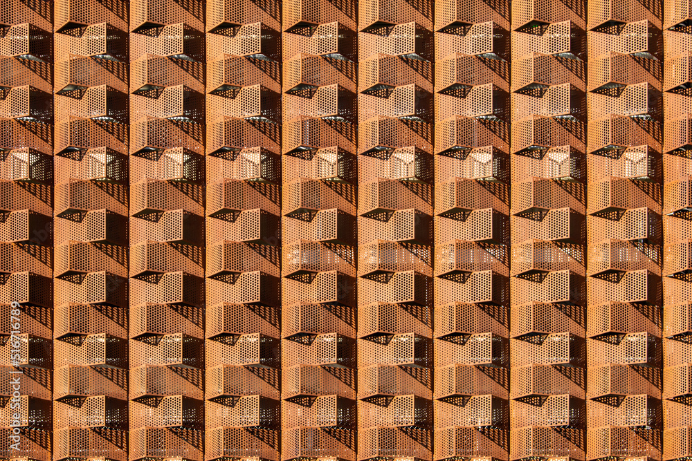 Horizontal Shot of a Rusty Metal Design of a Building's Exterior. Horizontal orientation of a rusty metal design of a building's exterior showing a somewhat crisscrossing pattern. Horizontal Shot of a Rusty Metal Design of a Building's Exterior. Horizontal orientation of a rusty metal design of a building's exterior showing a somewhat crisscrossing pattern.