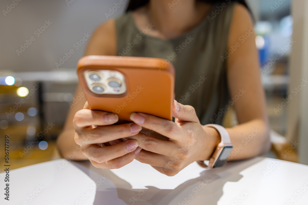 Woman use of mobile phone at coffee shop