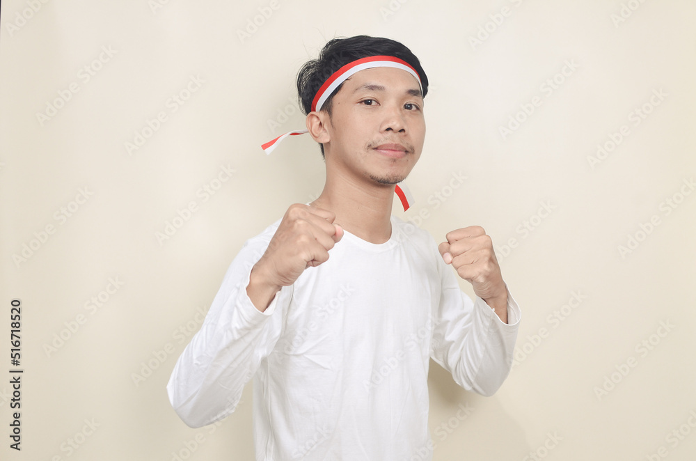 Indonesian man clenched both fist showing excitement when celebrating independence day