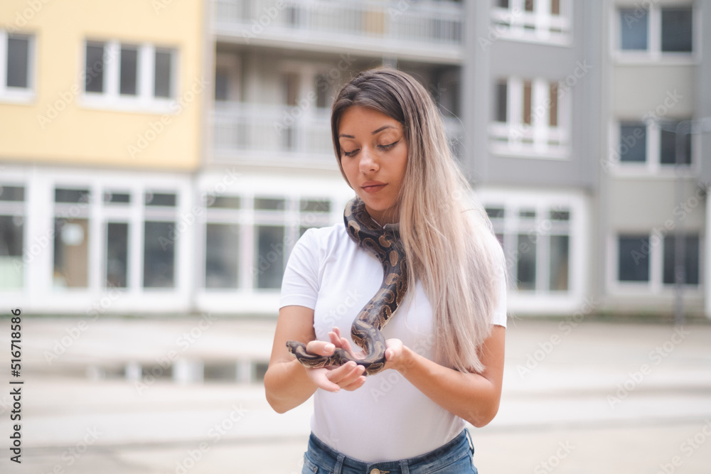 Long hair woman and a snake in the urban environment