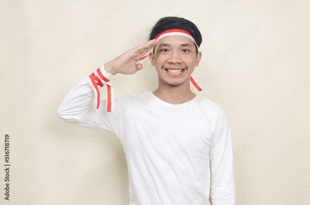 Fototapeta premium asian man in white shirt wearing red and white ribbon on his head celebrating independence