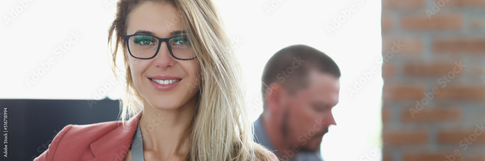 Fototapeta premium Stunning worker woman in presentable suit on working place, colleagues work together