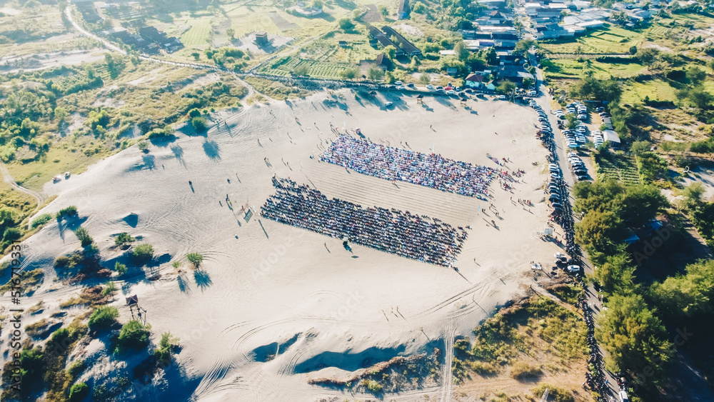 Aerial View People around Parangkusumo sand dunes are praying Eid al-Fitr in the morning