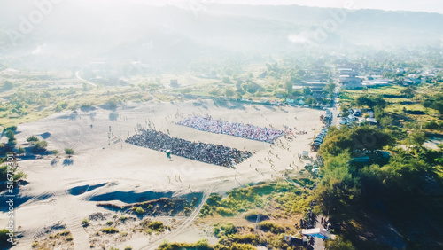 Aerial View People around Parangkusumo sand dunes are praying Eid al-Fitr in the morning photo