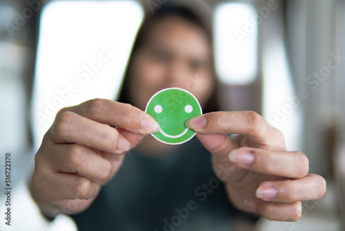 Customer Experience Concept, happy women holding the Excellent Smiley Face and Rating for a satisfaction survey, and positive customer feedback testimonial.