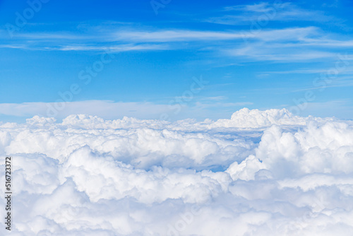 Clouds from above. View from airplane. blue sky view from plane. sky wallpaper with space for your text . Aerial view of the blue sky. High in the Heavens. View from Airplane Window