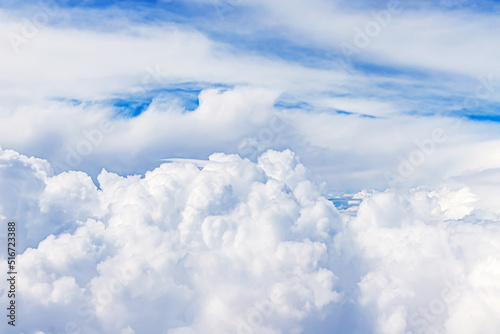 Clouds from above. View from airplane. blue sky view from plane. sky wallpaper with space for your text . Aerial view of the blue sky. High in the Heavens. View from Airplane Window