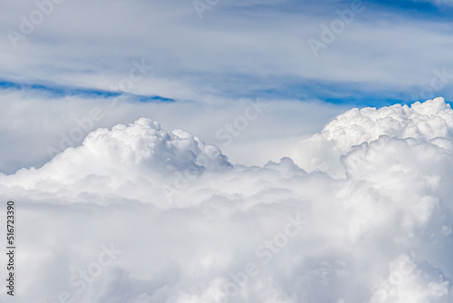 Clouds from above. View from airplane. blue sky view from plane. sky wallpaper with space for your text . Aerial view of the blue sky. High in the Heavens. View from Airplane Window