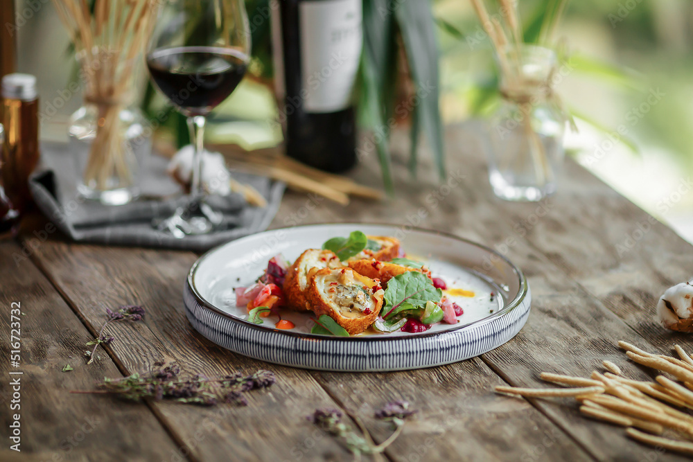 Gourmet fried rolls dish with red wine on wooden background Gourmet fried rolls dish with red wine on wooden background