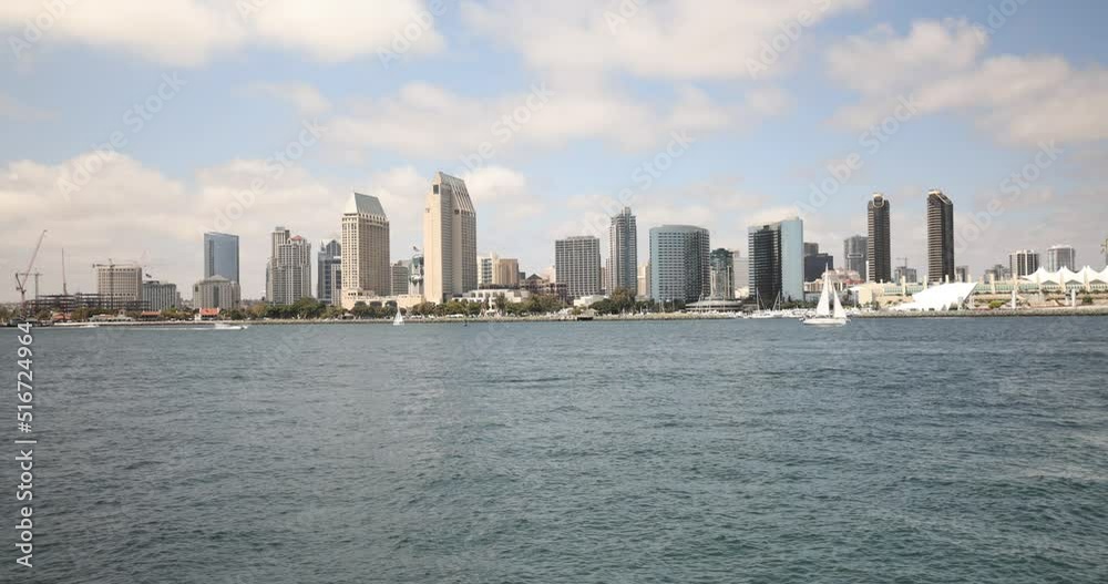San Diego, California from a boat with the city center in the background and passing boats. San Diego, California from a boat with the city center in the background and passing boats.