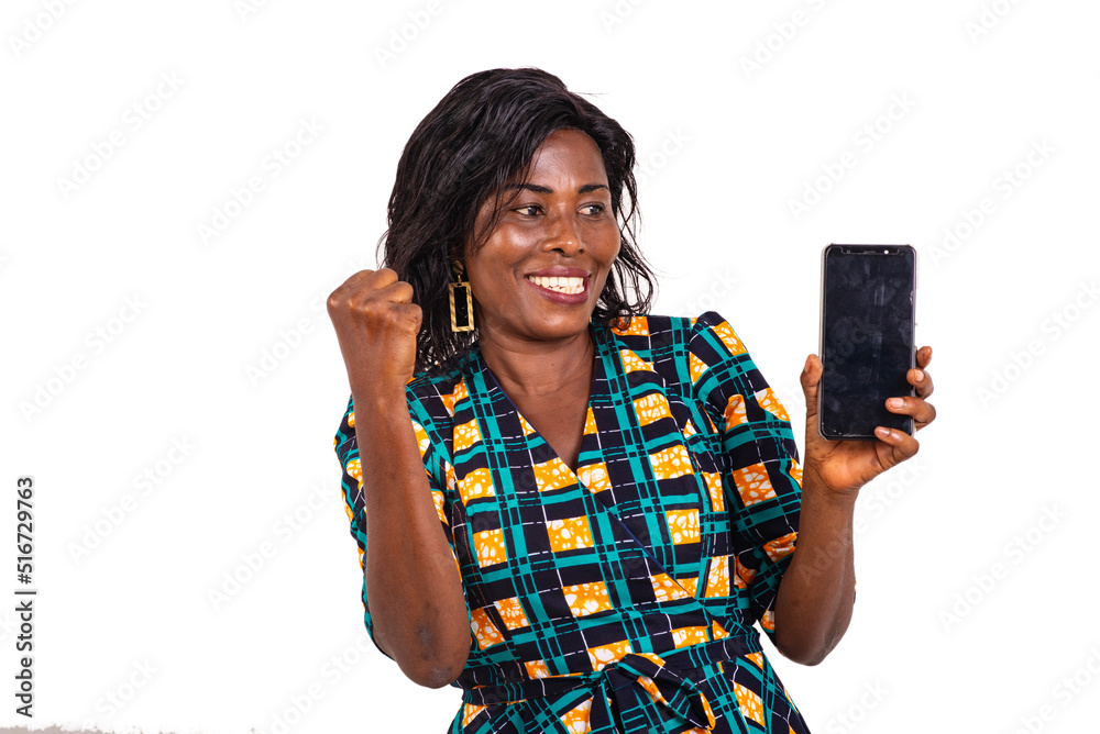 happy woman holding mobile phone and making winning gesture. happy woman holding mobile phone and making winning gesture.