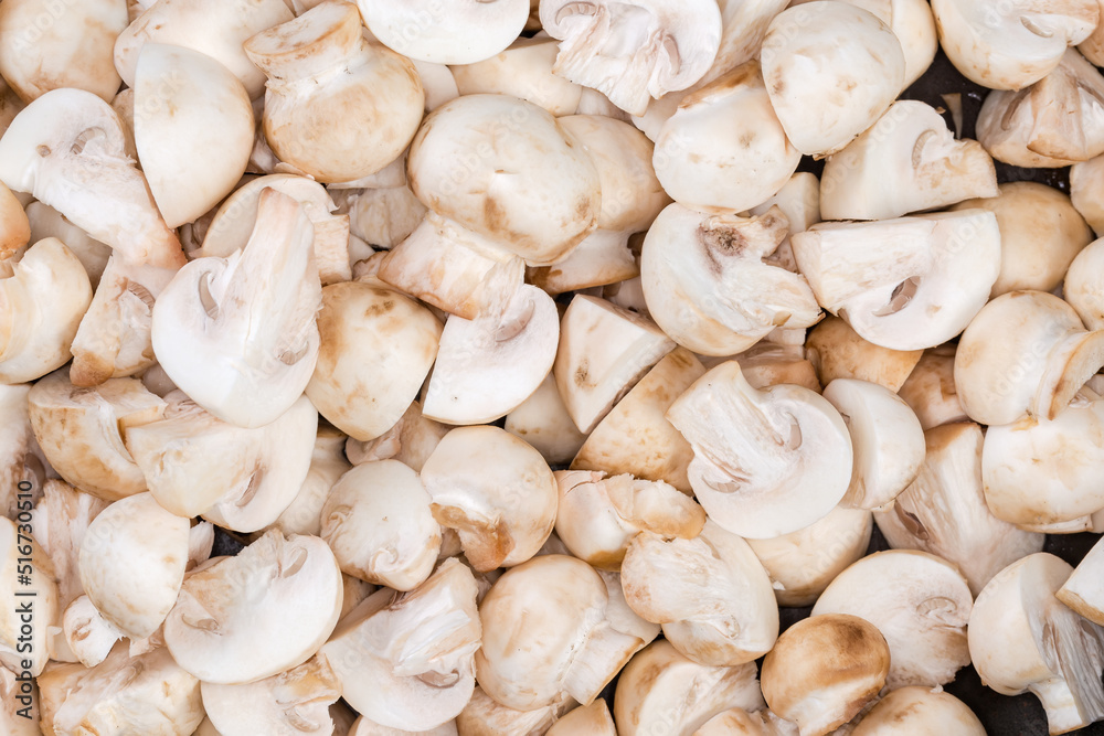 Background of raw sliced button mushrooms, top view close-up Background of raw sliced button mushrooms, top view close-up