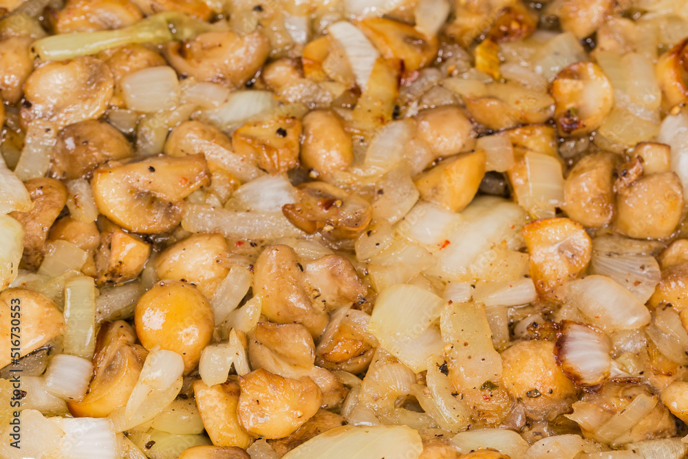 Fried sliced button mushrooms with onion, close-up Fried sliced button mushrooms with onion, close-up
