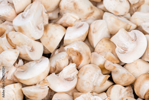 Raw sliced cultivated button mushrooms, close-up in selective focus