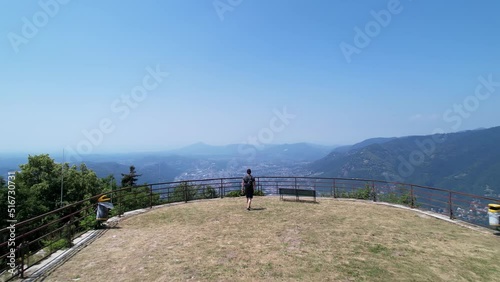 Scenic overlook of Lake Como and city from Faro Voltiano. Person walks up to vista point. Aerial drone. photo
