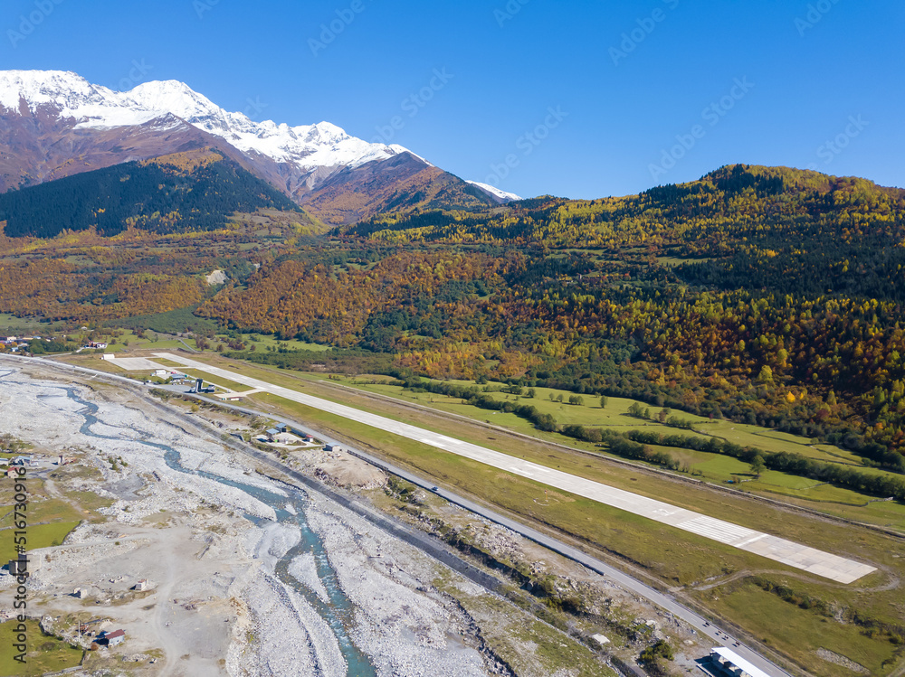Beautiful drone view of Mestia village on a sunny bright autumn day, Upper Svaneti, Georgia. Runway in the mountains of Svaneti