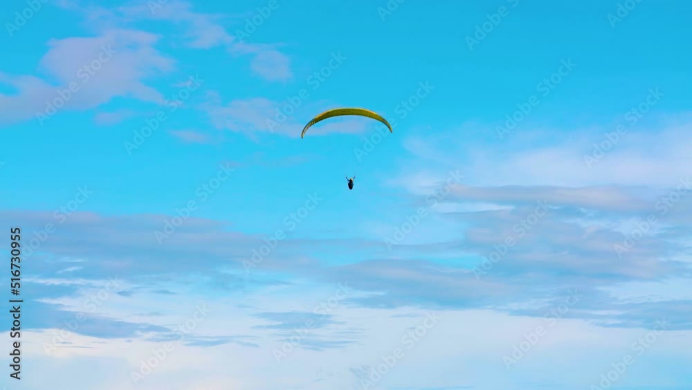 Paragliding in the Windy Blue Sky Pan Right Slow-Mo 4k Paragliding in the Windy Blue Sky Pan Right Slow-Mo 4k