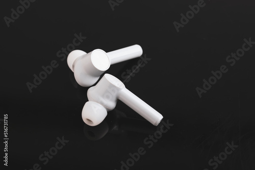 Technology concept   wireless ear bud or headphone on black background.