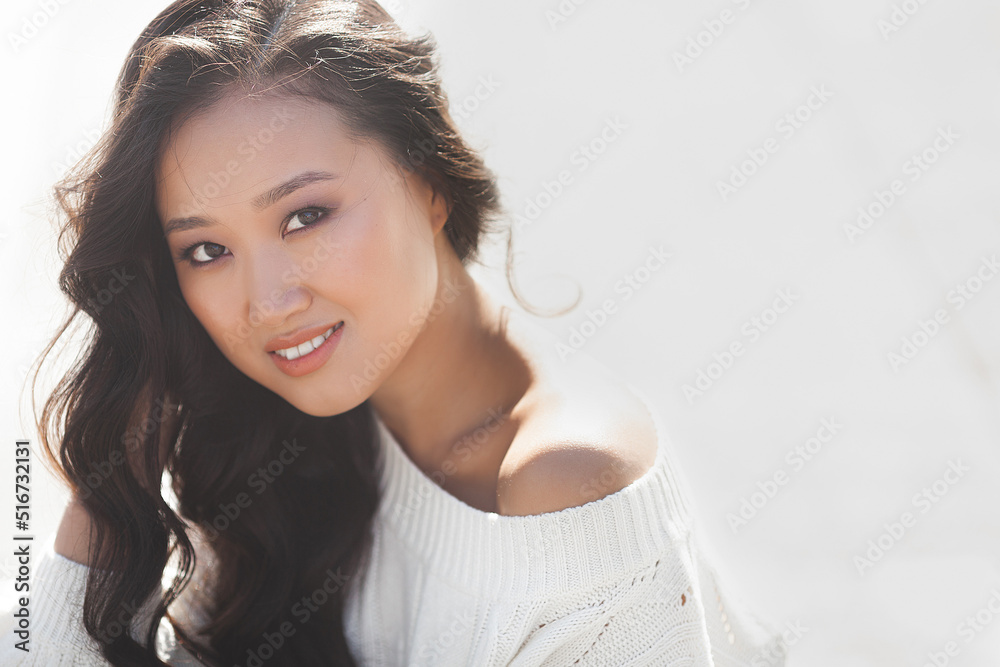 Fototapeta premium Beautiful woman outdoors. Pretty lady on urban background. Asian female closeup portrait.