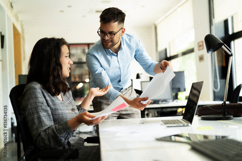Fototapeta premium Colleagues arguing in office. Angry businessman yelling at his collegue.