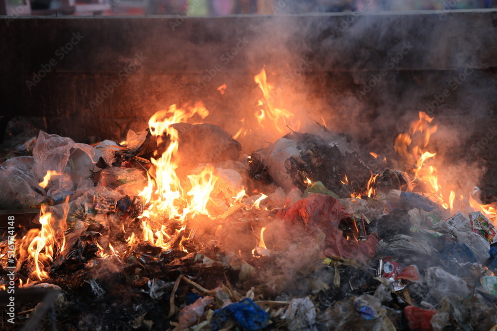 burning garbage in public places. burning trash in a public place. Environmental pollution due to waste burning burning garbage in public places. burning trash in a public place. Environmental pollution due to waste burning