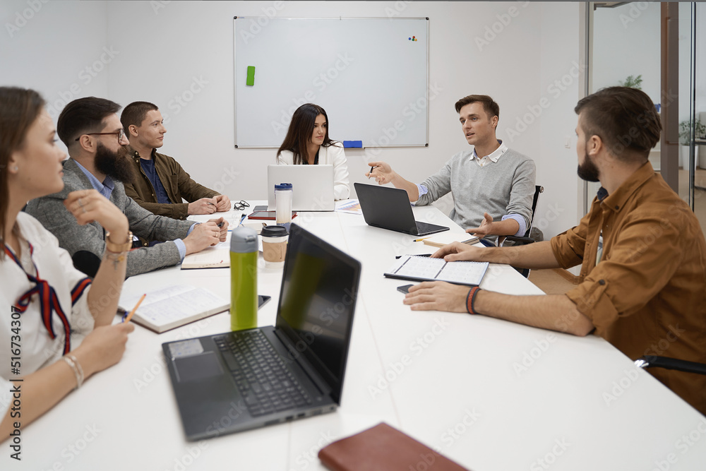 Making great decisions. Team and manager discussing during the meeting in IT office