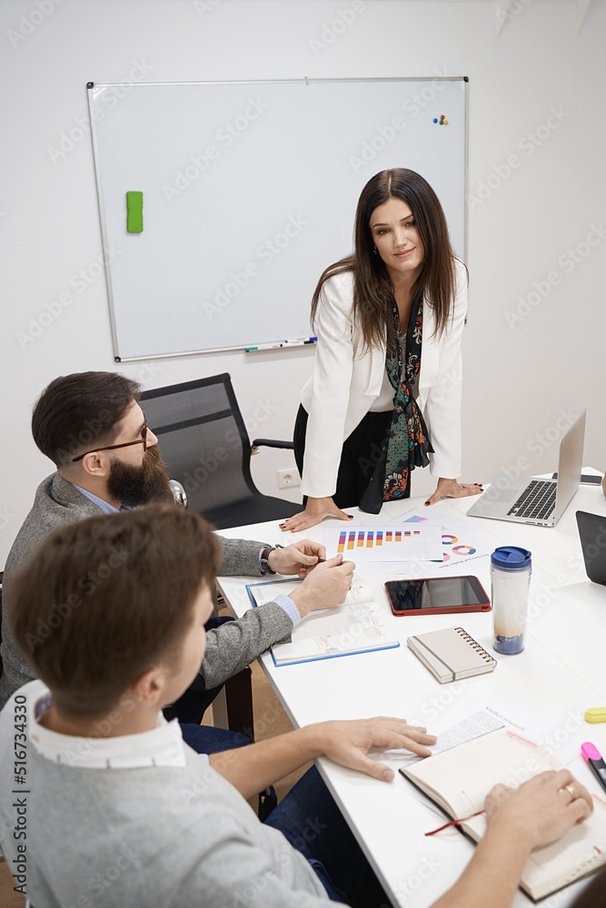 Female manager or team leader. Team and manager discussing during the meeting in IT office