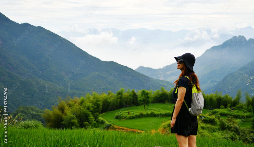 Naklejka premium an Asian lady standing on the terraces
