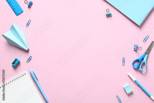 Back to school concept. Flat lay blue school supplies on pink table. Creative layout.