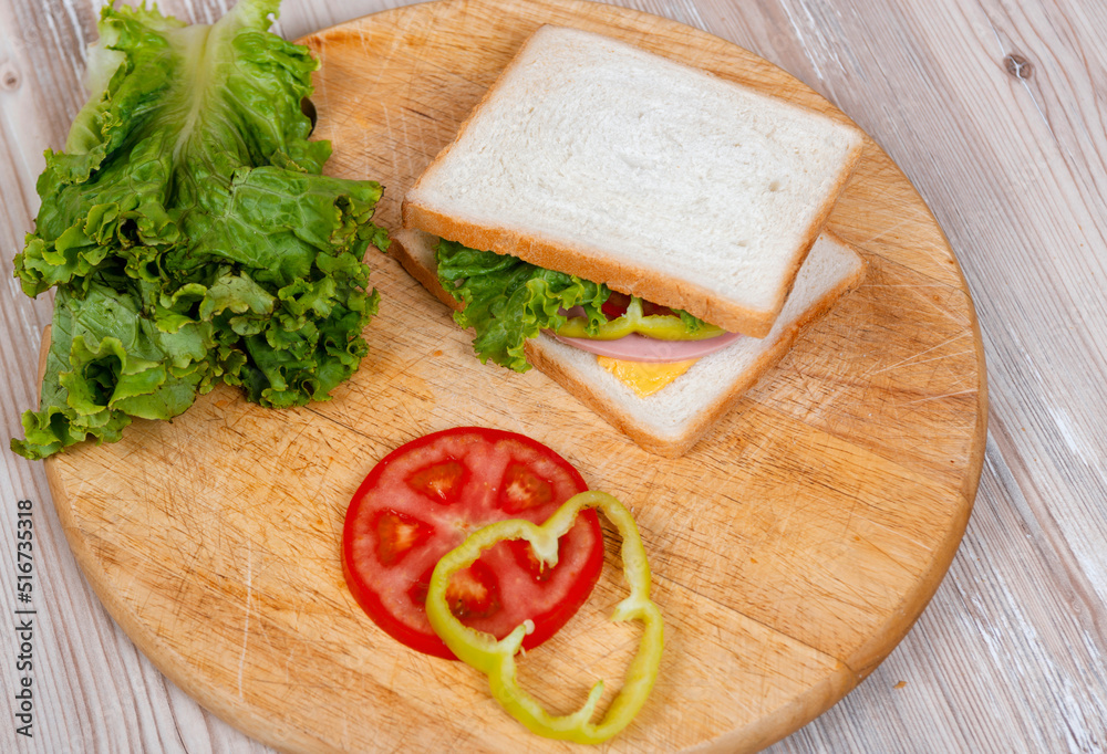 Many ingredients to make a sandwich on wooden desk