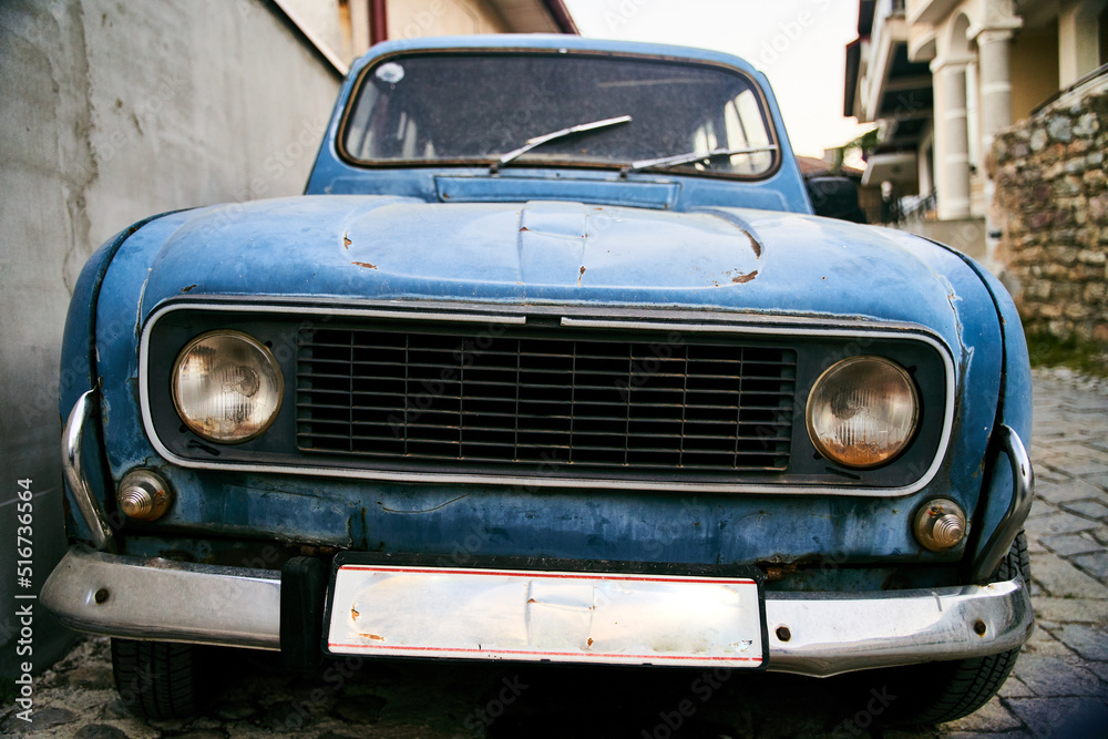 Ohrid, Macedonia - May 15, 2021: Retro vintage old blue car parking on a cobblestone street in Ohrid Old Town, North Macedonia. High quality photo