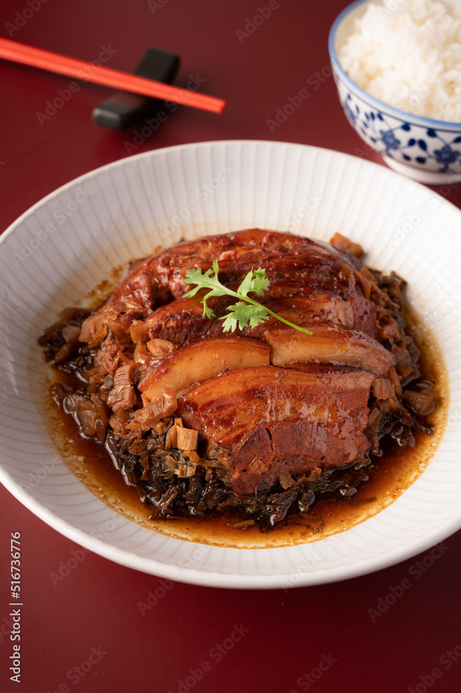 Braised Pork Belly with Preserved Mustard Green on with rice red background