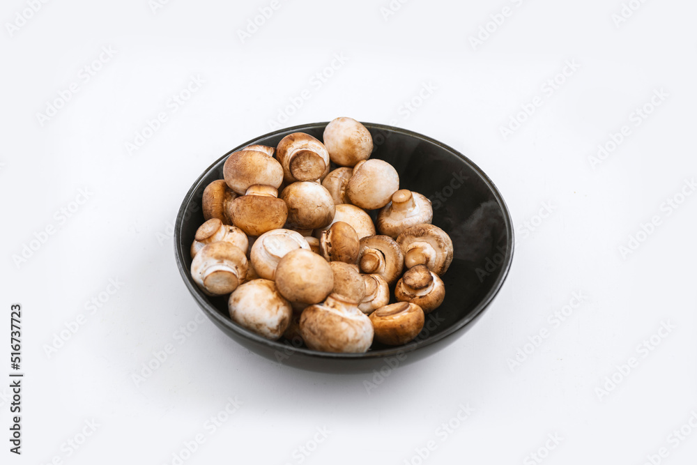 mushrooms champignon in bowl on white background mushrooms champignon in bowl on white background