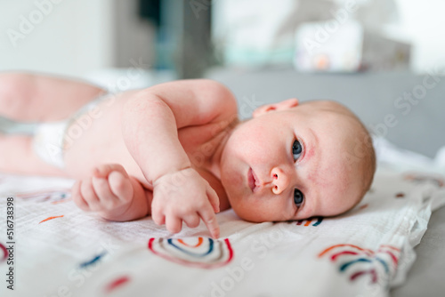 A two-month-old baby is lying, a cute portrait of a Caucasian newborn