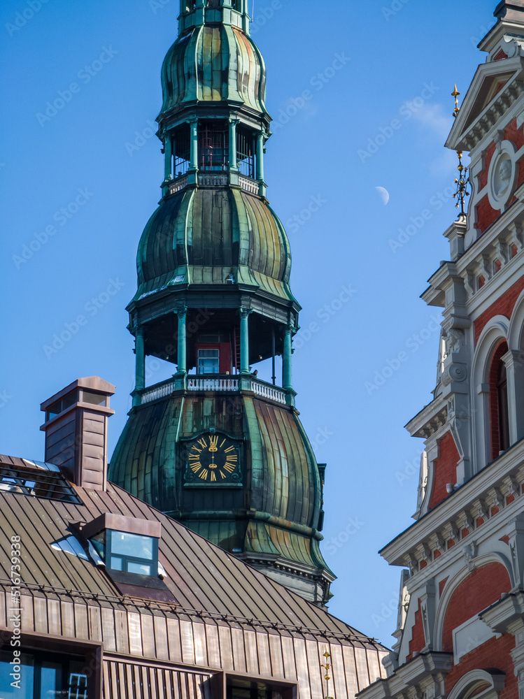 The spire with the clock of St. Peter`s Church. Landmark of Riga, Latvia.
