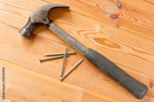 Nails and hammer on a table