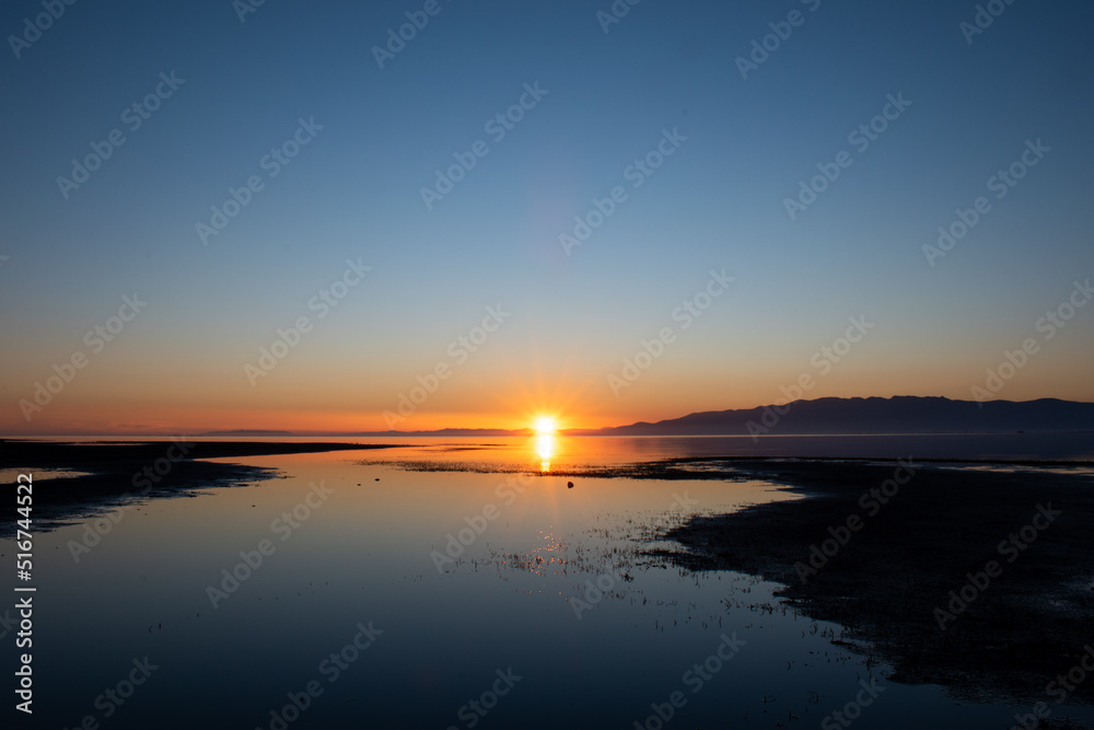 Sunset on the sea with reflections on the calm water