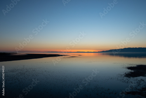 After the sunset on the sea with reflections of on the calm water