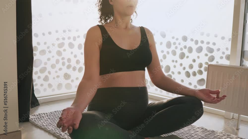 Happy Attractive Pregnant woman practice yoga lotus pose to meditation smile with big belly after wake up in the morning. Happy Attractive Pregnant woman practice yoga lotus pose to meditation smile with big belly after wake up in the morning.