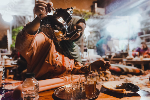 Moroccan woman nigh serving tea during Ramadan. Night life