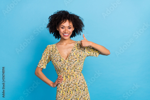 Portrait of attractive cheerful wavy-haired girlshowing thumbup ad agree isolated over bright blue color background photo