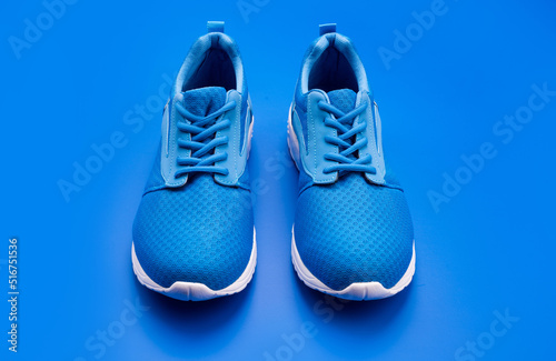 pair of comfortable blue sport shoes on blue background, shoes