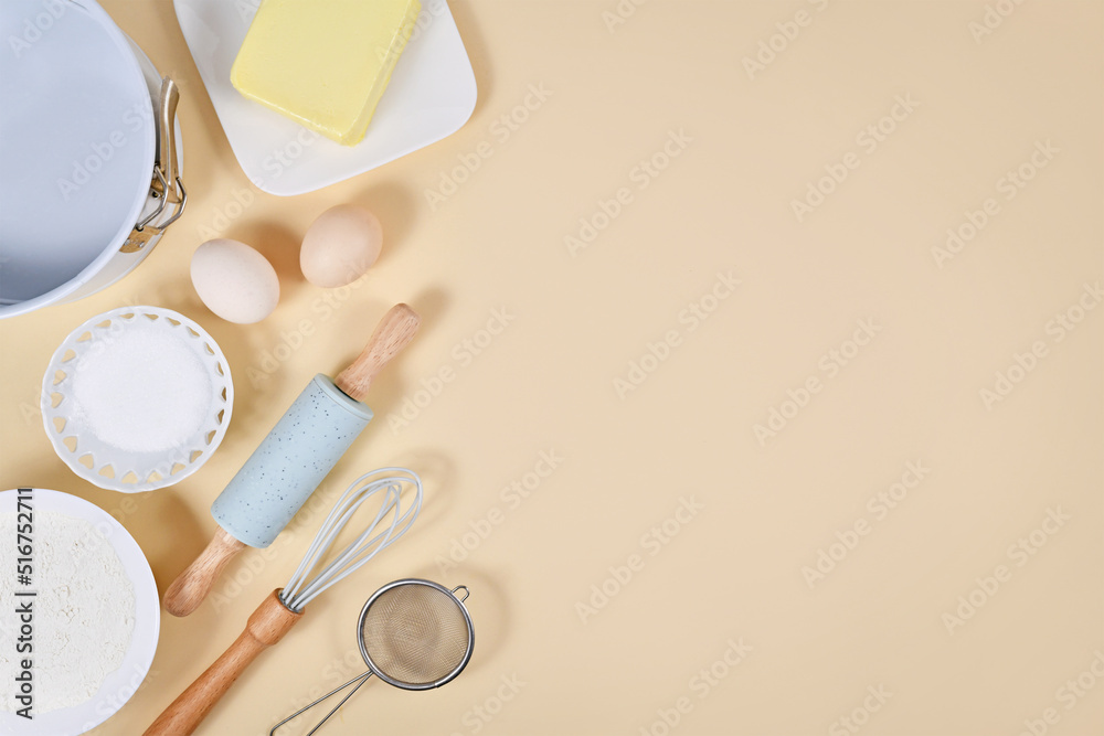 Cake dough ingredients and baking tools on beige background with copy space Cake dough ingredients and baking tools on beige background with copy space