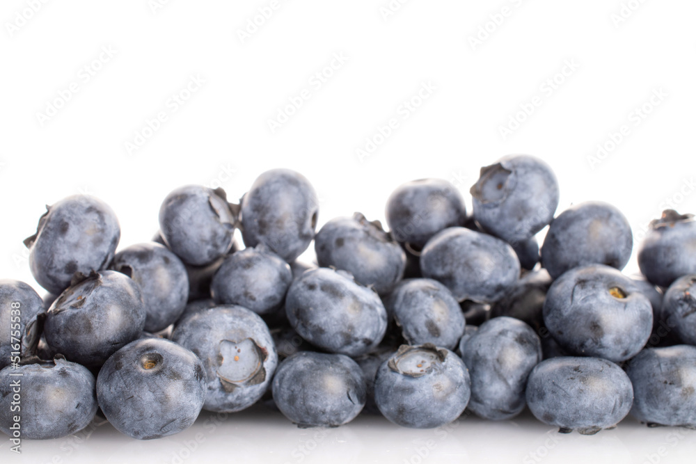 Several berries of organic ripe blueberries, close-up, on a white background. Several berries of organic ripe blueberries, close-up, on a white background.