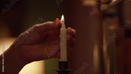Woman is lighting the candle